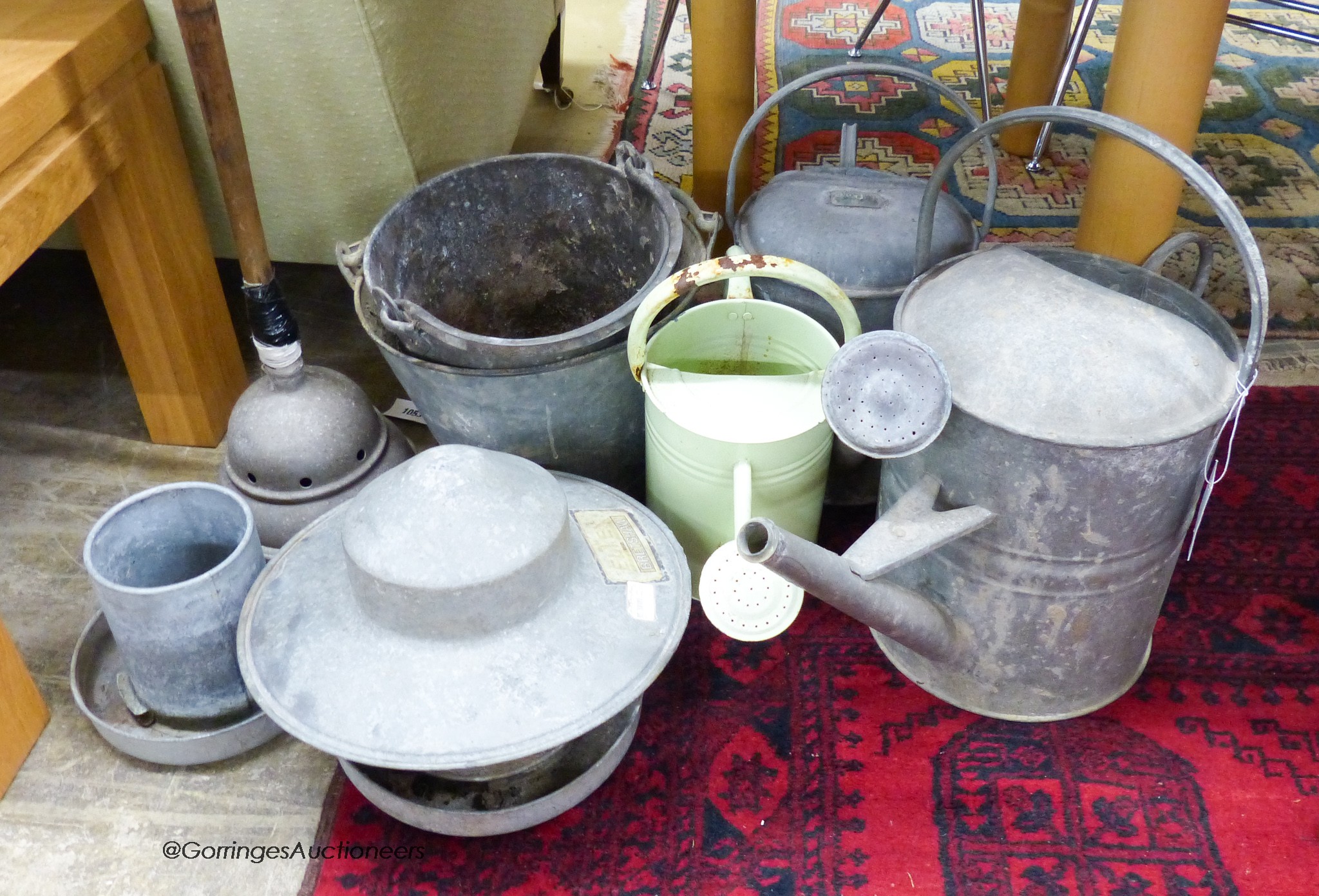 A quantity of galvanized buckets, watering cans and other items.
